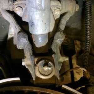 Top of Suspension - Rusty and worn Shock Absorber. Remember to clean up around the upper ball joint and take note of the number of spacer used so you can put them back in correctly